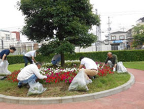 Volunteers at work planting flowers and pulling weeds